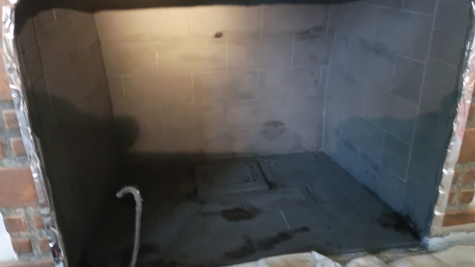 Clean fireplace firebox after soot and debris removal